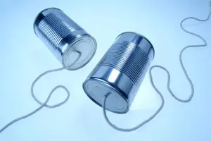 Two tin with some thread and a blue background