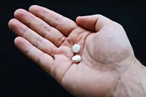 Two small pills of medicine in the hand