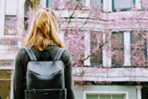 Back image of a girl with black backpack