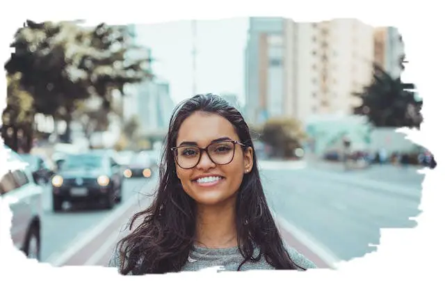photo of a woman smiling near a busy city street