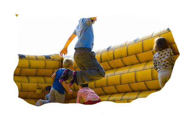 child jumping around in bounce house