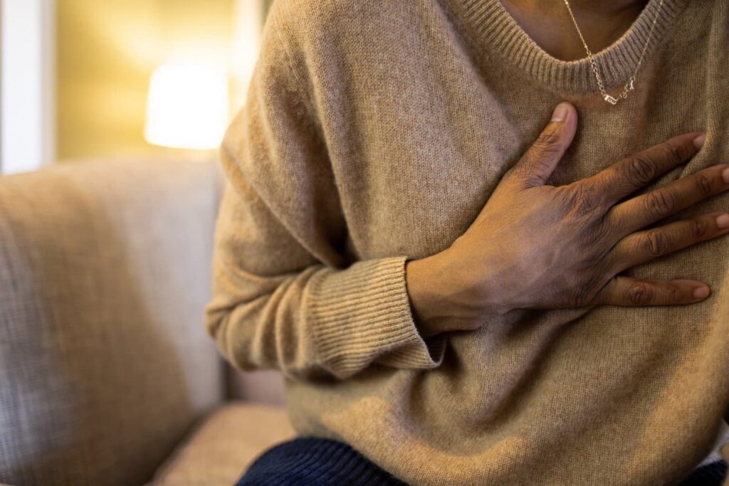 woman touching her chest